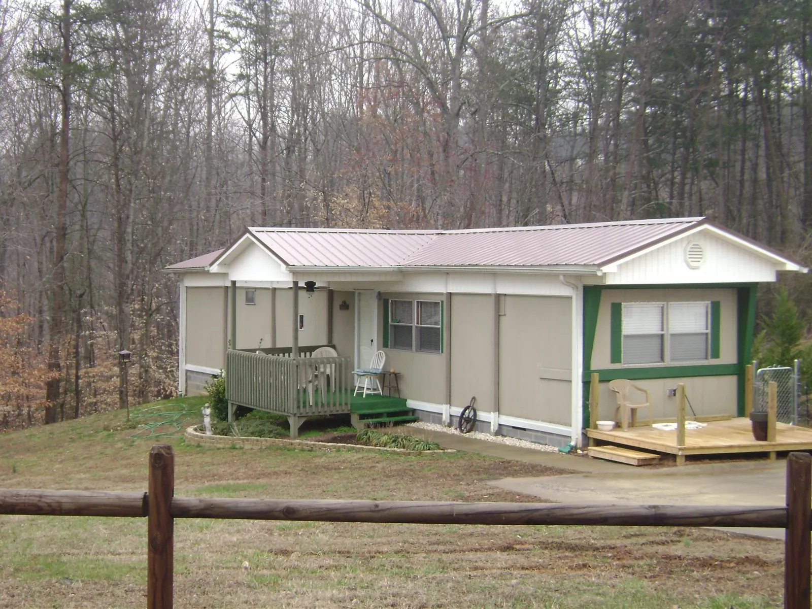 Mauve metal roof on a manufactured home with a new front deck in Cortland